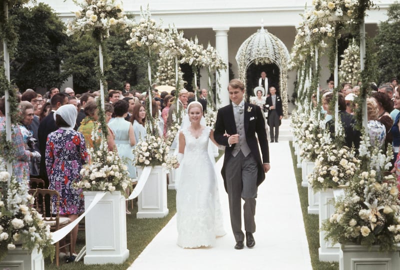 (Original Caption) Washington, DC.: After taking their vows, Edward Finch Cox and Tricia Nixon Cox walk through rows of flowers past their guests en route to the White House for the reception, following their wedding in the White House rose garden. The bride is the daughter of president Richard Nixon.