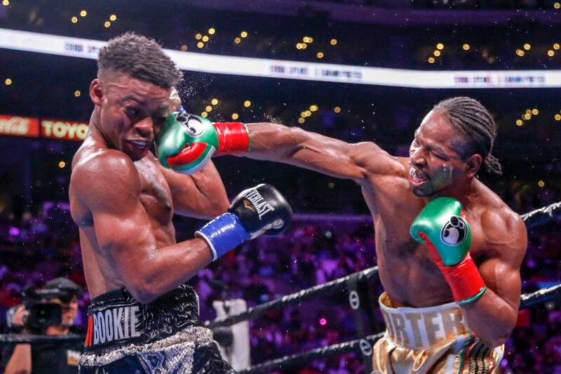 Shawn Porter, right, lands a punch to the face of Errol Spence Jr during the WBC  and IBF  welterweight title fight in Los Angeles on Saturday, September 28. Spence Jr won the bout via a split decision. AP