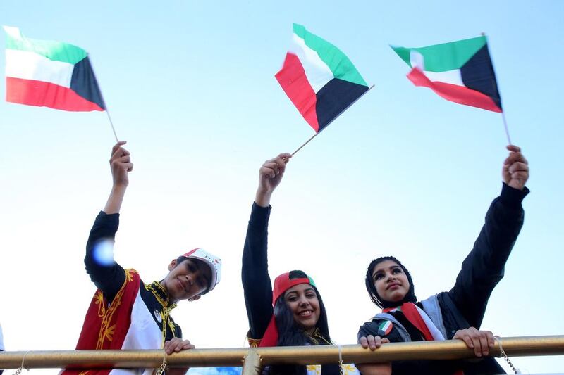 Young women in Kuwait City join in celebrations for the country’s 56th Independence Day. Yasser Al Zayyat / AFP 