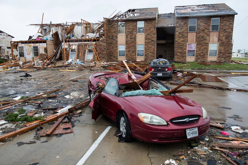 A damaged car sits outside a heavily damaged apartment complex in Rockport, Texas, after Hurricane Harvey struck the area. Courtney Sacco / Corpus Christi Caller-Times via AP