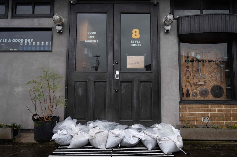 Sandbags in front of a closed restaurant in Izumi. AFP