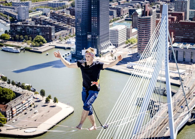 Estonian slackliner Jaan Roose walks at a height of almost 188 metres over a webbing from De Rotterdam in the Wilhelminapier to the De Zalmhaven towers at the Erasmus Bridge, in Rotterdam, the Netherlands. EPA