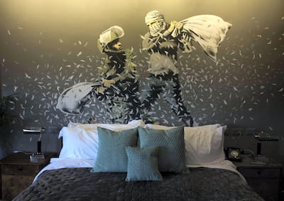 A wall painting by graffiti artist  Banksy showing Israeli border policeman and Palestinian in a pillow fight  in one of the rooms of the "The Walled Off Hotel" in the West Bank city of Bethlehem, Sunday March 5, 2017.  The nine-room hotel named "The Walled Off Hotel" will officially open on March 11. (Photo by Heidi Levine/Sipa Press).//LEVINE_6U8A6083/Credit:Heidi Levine/SIPA/1703052107 *** Local Caption *** 00796308