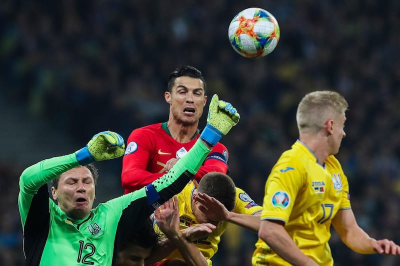 Ukraine's Andriy Pyatov  in action against Portugal`s Cristiano Ronaldo. EPA