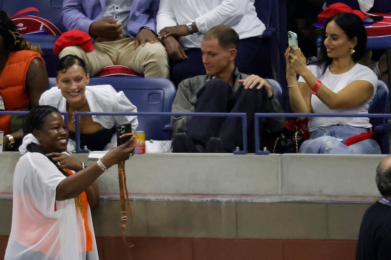 Model Bella Hadid poses for a selfie with a fan during a changeover in the match between Serena Williams and Danka Kovinic. Reuters