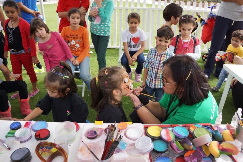 A group of youngsters eagerly await getting their faces painted, which was just one of the many activities during a fun-filled opening weekend at Mushrif Central Park. Delores Johnson / The National