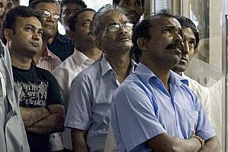 Men watch an Indian cricket league match outside a cafeteria on a side street in the Meena Bazar area of Bur Dubai.