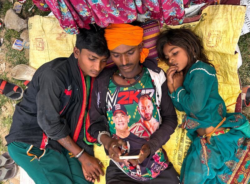 A nomadic family rests in shade outside their tent in Lalitpur district in the northern state of Uttar Pradesh, India