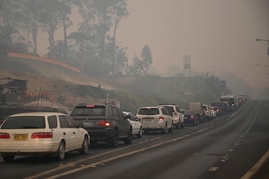 Cars line up to leave the Australian town of Batemans Bay in New South Wales on January 2, 2020. AFP