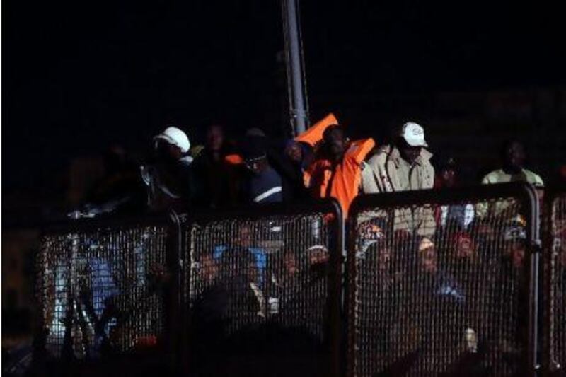 African migrants disembark from a naval patrol boat at the Maltese port of Valetta after being rescued at sea. With tens of thousands of migrants from North Africa arriving on its shores or stranded by smugglers in its territorial waters, Malta requires assistance from the European Union and others to meet the challenges of migration.