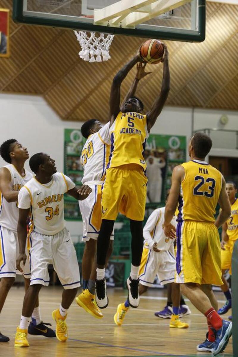 Montverde Academy’s Marquez Letcher-Ellis, centre, grabs a rebound over several Simeon players during their game at the Al Shabab Sports Club in Mamzar on Tuesday. Simeon won, 98-78. Antonie Robertson / The National

