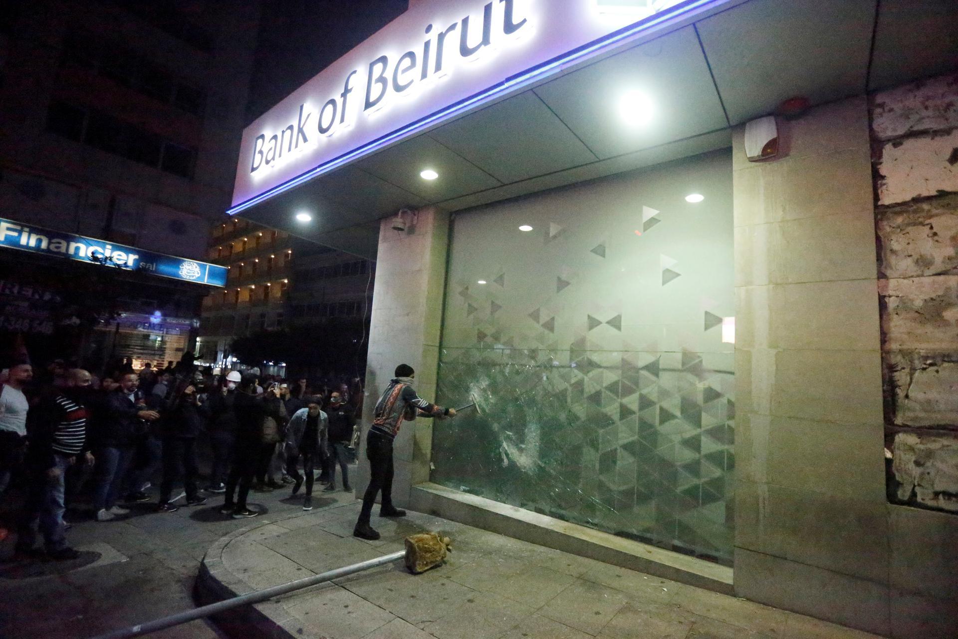 Protesters smash the window of a Bank of Beirut office as demonstrations against the government continue in Beirut, Lebanon.  Reuters