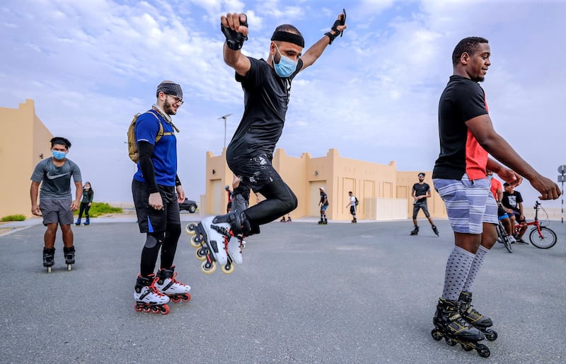 Abu Dhabi, United Arab Emirates, August 21, 2020.   The Madrollers skating group at the Al Wathba Bicycle Track do a  8 km. fun sprint.
  The skating group has members from Dubai and Abu Dhabi.  They encourage safety and discipline on roller-skates, skateboard, long-board and bicycles.  --Rollerbladers do limbering exercises and some jumps before going on the 8 km fun sprint.
Victor Besa /The National
Section:  Photo Project
Reporter: