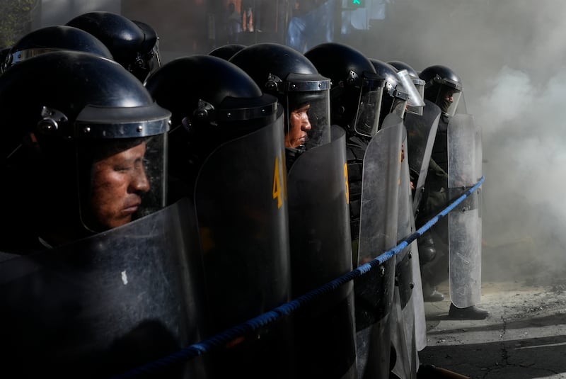 Police advance on a group of teachers protesting against forced retirement in La Paz, Bolivia. AP