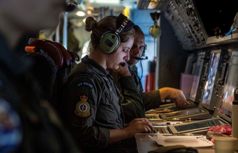 A New Zealand air crew map the extent of the damage in Tonga from a P-3K2 Orion aircraft. Reuters