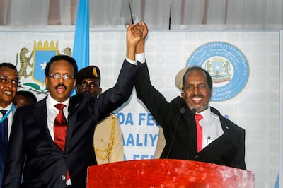 Hassan Sheikh Mohamud, right, marks his election win with incumbent leader Mohamed Abdullahi Mohamed, left, at the Halane military camp in Mogadishu, on Sunday. AP