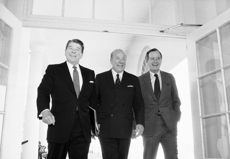 Secretary of State George Shultz walks between President Ronald Reagan and Vice President George Bush at the White House on January 9, 1985 after two days of arms talks with the Soviet Union in Geneva. AP