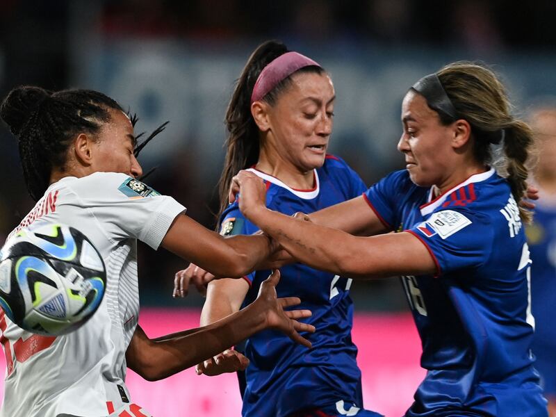 Switzerland forward Eseosa Aigbogun, left, fights for the ball with Philippines duo Sofia Harrison, right, and Katrina Guillou. during the Women's World Cup 2023 Group A opener at Dunedin Stadium in Dunedin on July 21, 2023. Switzerland won the match 2-0. AFP