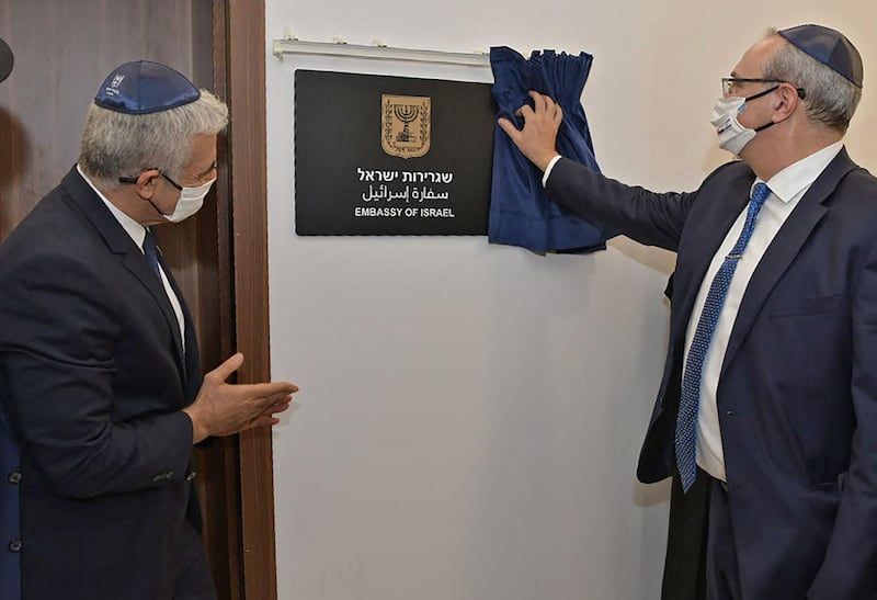 Israeli Foreign Minister Yair Lapid, left, and Israeli Foreign Ministry director general Eitan Na'eh during the inauguration of the Israeli embassy in Abu Dhab.  AFP