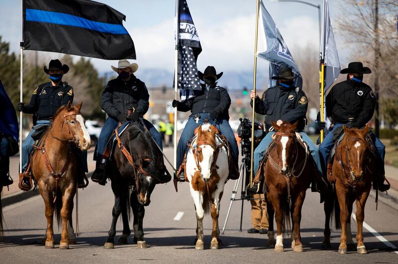 Mounted officers wait for police vehicles to approach the memorial service for slain officer of the Boulder Police, Eric Talley, who was killed during a mass shooting on March 22 in Lafayette, Colorado, US. Reuters