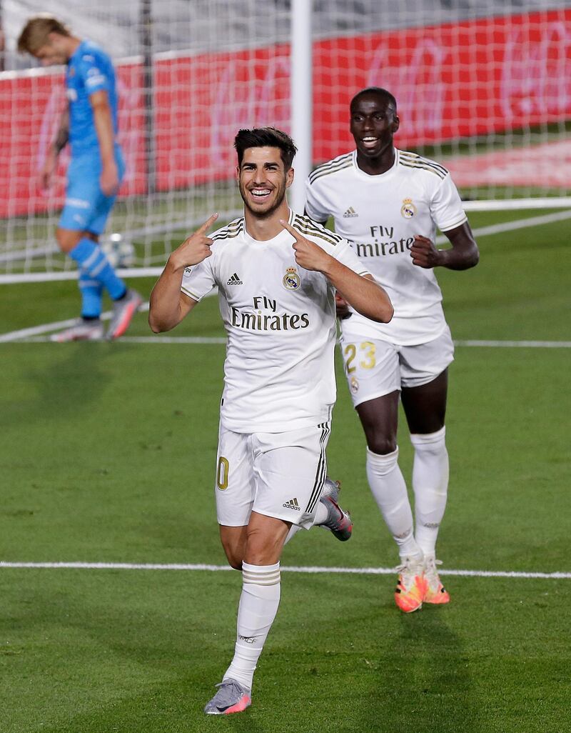Real Madrid's Marco Asensio, left, celebrates with his teammate Ferland Mendy after scoring at the Alfredo di Stefano stadium. AP