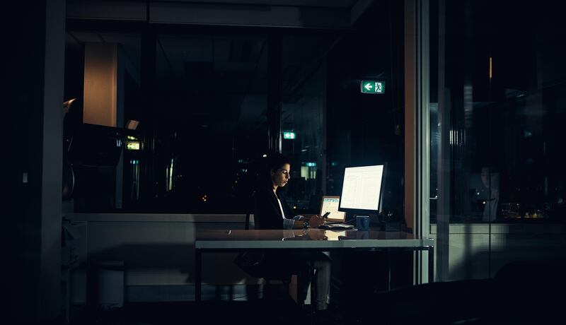 Shot of a businesswoman working late in an office. Getty Images