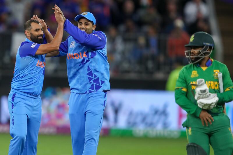 India's Mohammed Shami, left, is congratulated after dismissing South Africa's Temba Bavuma, right. AP 