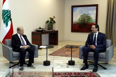 Lebanon's President Michel Aoun meets with former Prime Minister Saad Hariri at the presidential palace in Baabda on October 12. Dalati and Nohra, HO via REUTERS
