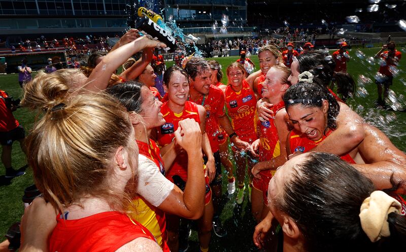 Gold Coast Suns players celebrate after winning the Australian Football League Women's final against the West Coast Eagles in Melbourne. Getty Images