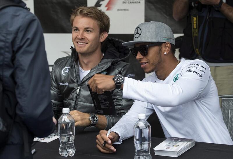 Mercedes driver Nico Rosberg, left, wants to beat teammate Lewis Hamilton on the track and not in the press as the German was cautious with reporters on Friday ahead of the Canadian Grand Prix. Paul Chiasson / AP Photo



