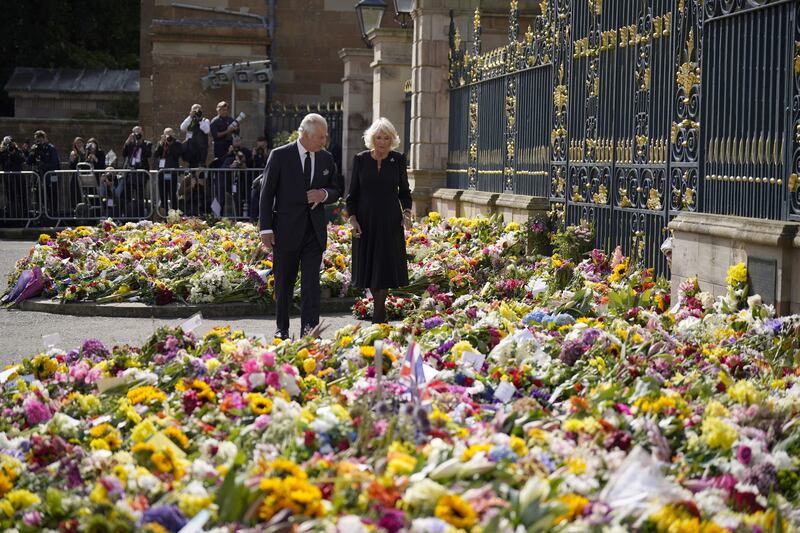 King Charles and the Queen Consort Camilla view floral tributes left outside Hillsborough Castle. PA