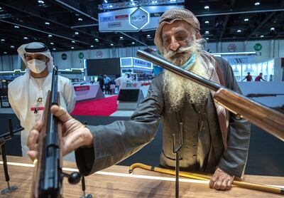 Ali Mohammat Al Shehhi checks out some rifles at the Caracal stall at the Abu Dhabi International Hunting and Equestrian Exhibition. Victor Besa / The National