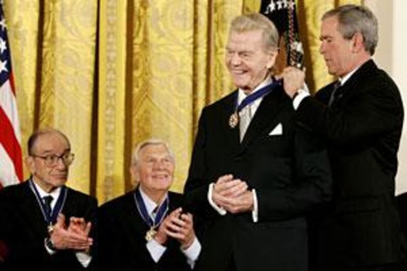 Then-US President George W Bush awards the Presidential Medal of Freedom to long-term radio commentator Paul Harvey.