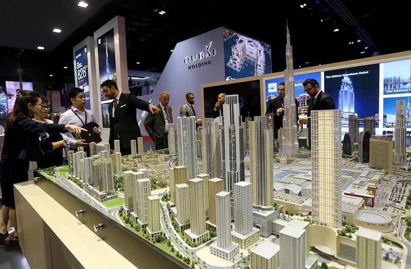 Visitors browse scale models at the Emaar stand at Cityscape Global 2014. Satish Kumar / The National