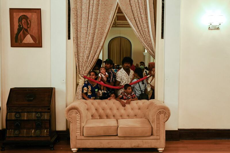 People visit Mr Rajapaksa's official residence in Colombo. It was reported on Wednesday that he had fled the country for the Maldives. AFP