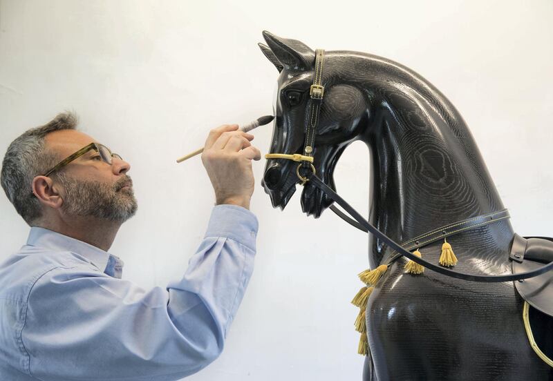 BETHERSDEN,UK 20th March 2019. Rocking-horse artist Matthew Clift adds the final touches to a black arab rocking horse at the  Stevenson Brothers rocking horse makers workshop  in the village of Bethersden, near Ashford, United Kingdom. Stephen Lock for the National 