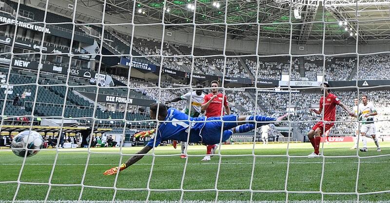 Moenchengladbach's French forward Marcus Thuram, second left, scores. AFP