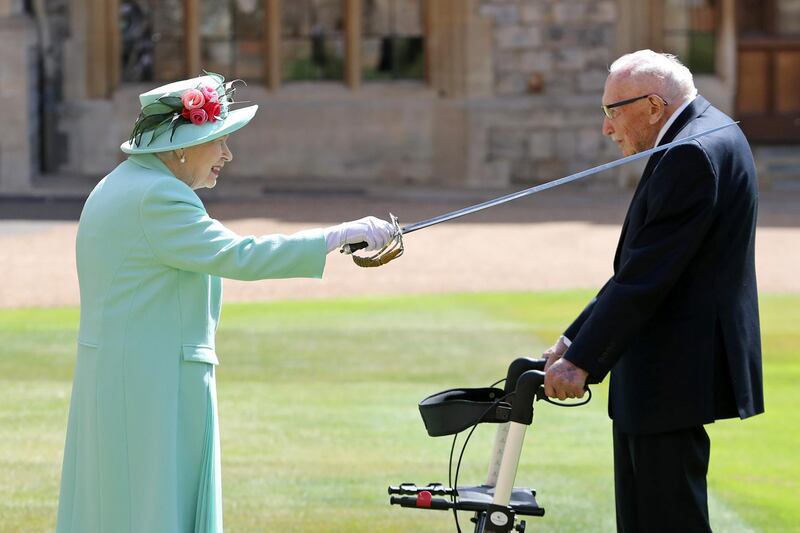 Britain's Queen Elizabeth awards Captain Tom Moore with the insignia of Knight Bachelor at Windsor Castle, in Windsor, Britain July 17, 2020. Chris Jackson/Pool via REUTERS