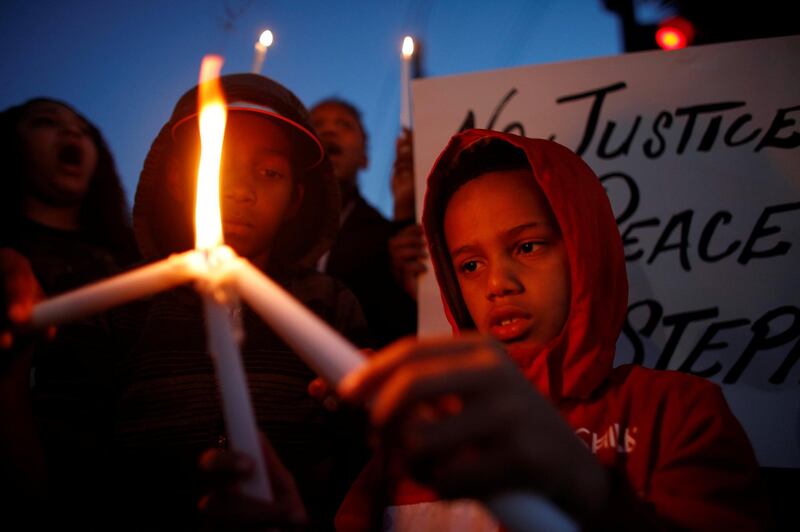 Jayden Sherman, right, and David Massey hold candles during a vigil to protest the police shooting of Stephon Clark, in Sacramento, California, US. Bob Strong / Reuters