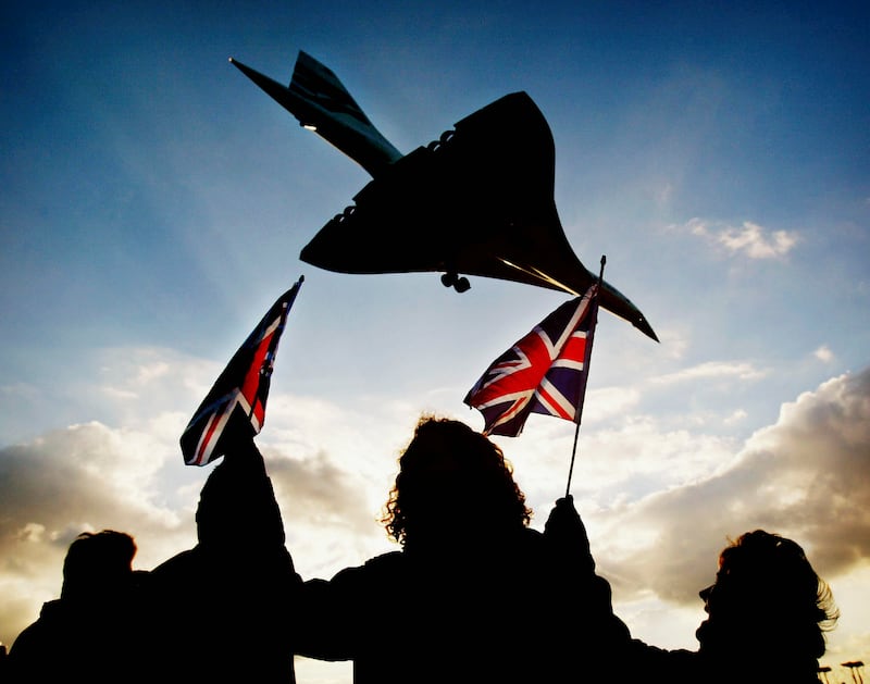 People watch the final Concorde flight land at Heathrow Airport in 2003. Although the venture was hit by cost overruns, everyone involved followed through because they had already made significant financial investments. Getty Images