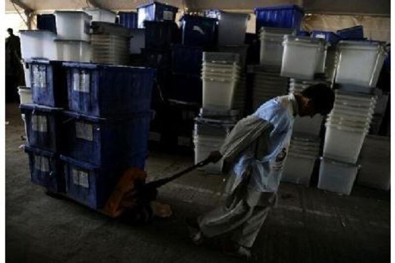 Afghan election workers sort ballot boxes at the Independent Election Commission warehouse in Kabul last month.