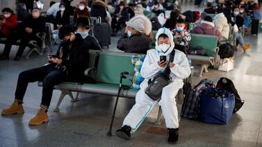 A man in a protective suit at Beijing Railway Station after China lifted its Covid-19 restrictions.  Reuters