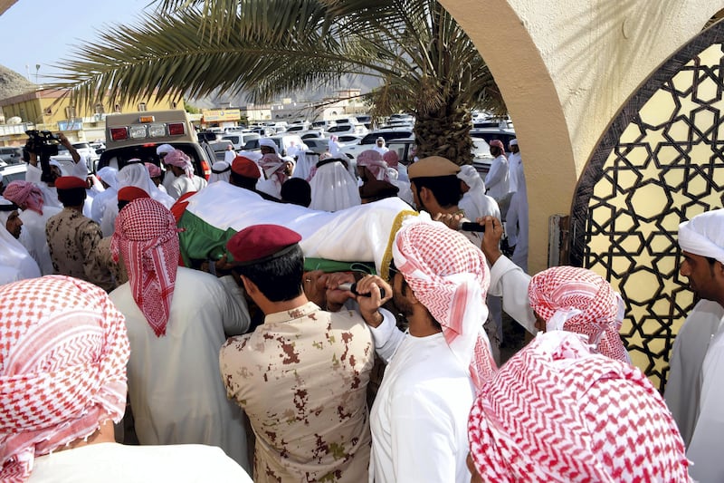 The body of Warrant Officer Mohammed Saeed Al Hassani is carried for burial in Fujairah on Saturday. Wam