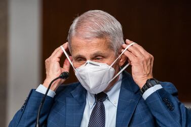 Dr.  Anthony Fauci, director of the National Institute of Allergy and Infectious Diseases and chief medical adviser to the president, right, is seen before a Senate Health, Education, Labor, and Pensions Committee hearing to examine the federal response to COVID-19 and new emerging variants, Tuesday, Jan.  11, 2022 on Capitol Hill in Washington.   (Shawn Thew / Pool via AP)