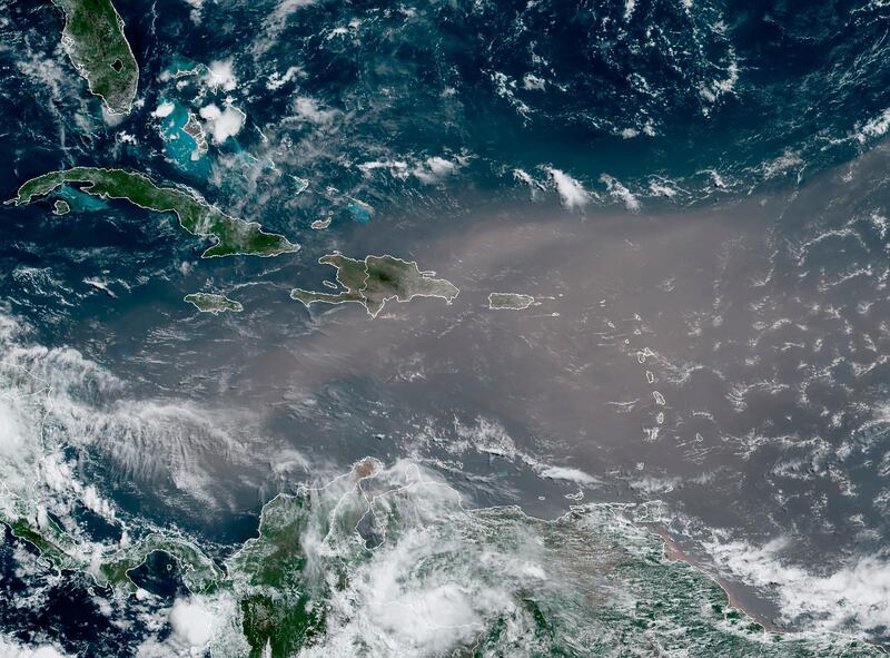 This satellite photo provided by the National Oceanic and Atmospheric Administration, NOAA, shows a could of dust coming from the Sahara desert arriving to the Caribbean Monday, June 22, 2020. The massive cloud of dust is blanketing the Caribbean as it heads to the U.S. with a size and concentration level that meteorologists say hasn't been seen in roughly half a century. (NOAA via AP)