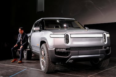 Rivian CEO RJ Scaringe with the R1T all-electric pickup truck at Los Angeles Auto Show. Reuters