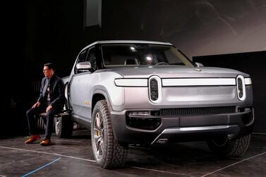 Rivian CEO RJ Scaringe with the R1T all-electric pickup truck at Los Angeles Auto Show. Reuters