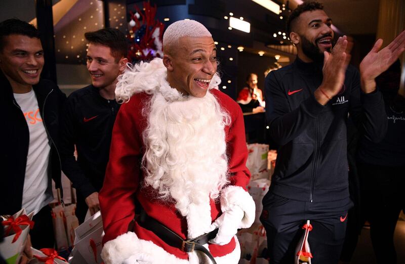 The PSG trio enjoy the gift giving. AFP