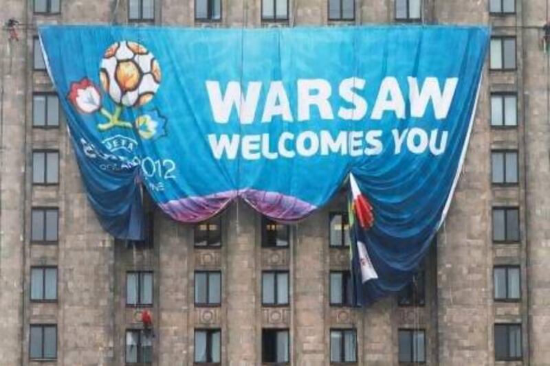 A giant Euro 2012 banner is spread on Warsaw's landmark, the Palace of Culture ahead of the tournament, which starts on Friday. Czarek Sokolowski / AP Photo