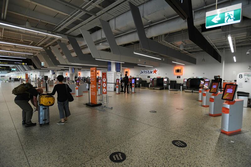 Passengers wait at a domestic check-in terminal at Melbourne Airport during the state's five-day lockdown designed to prevent the spread of the coronavirus.  EPA